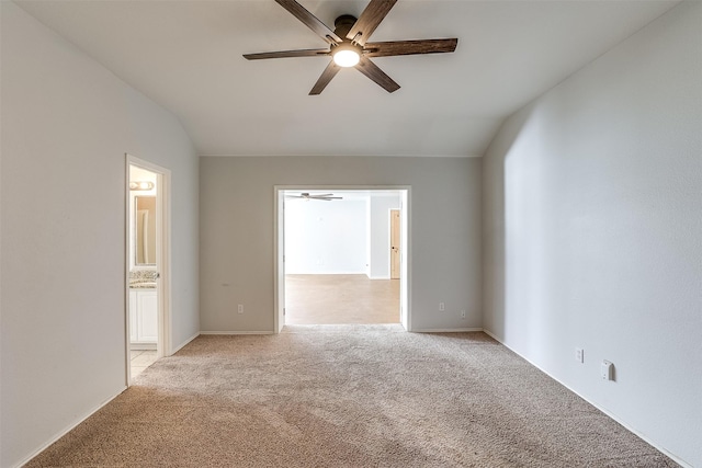 unfurnished room with vaulted ceiling, ceiling fan, and light colored carpet