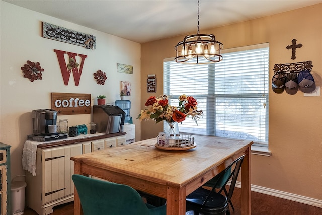 dining space with a chandelier, a wealth of natural light, and dark hardwood / wood-style floors