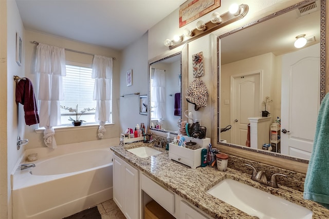 bathroom featuring a tub to relax in, tile patterned flooring, and vanity