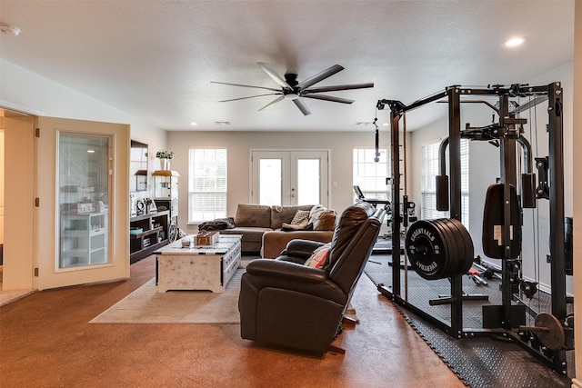 workout area featuring a textured ceiling, french doors, a wealth of natural light, and carpet