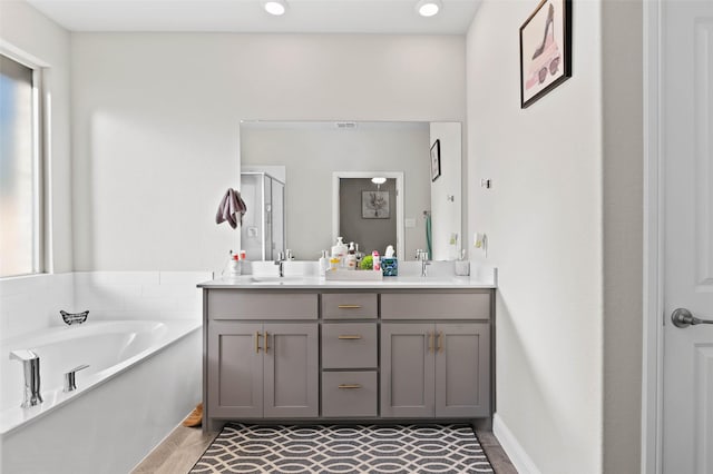 bathroom with plus walk in shower and vanity