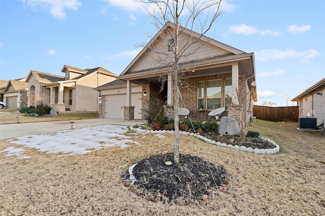 view of front of property with a garage and cooling unit