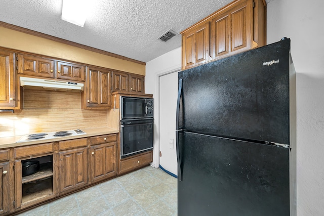 kitchen featuring black appliances, ornamental molding, backsplash, and a textured ceiling