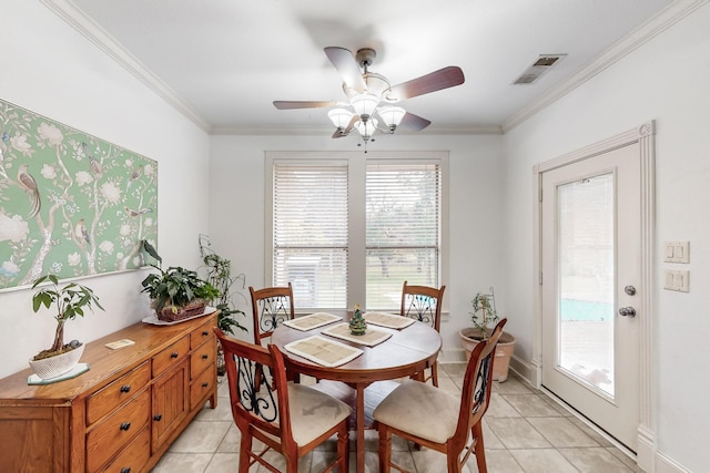 tiled dining room featuring ornamental molding and ceiling fan