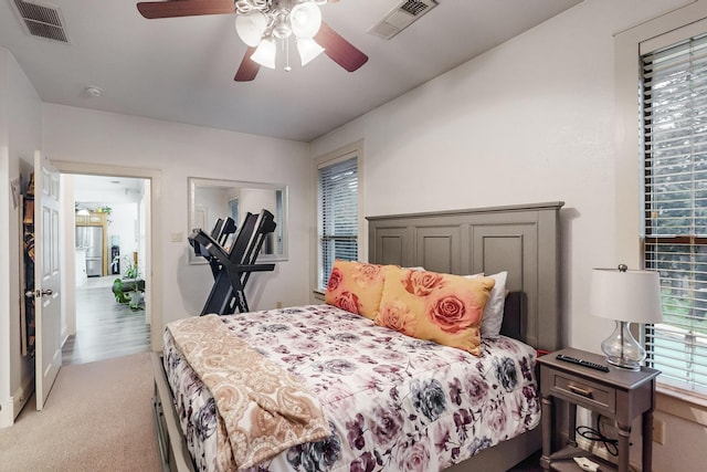 bedroom with ceiling fan and light colored carpet