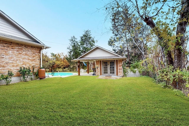 view of yard featuring french doors and an outdoor structure