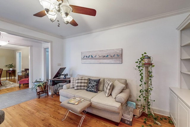 living room with ceiling fan, light hardwood / wood-style floors, and crown molding