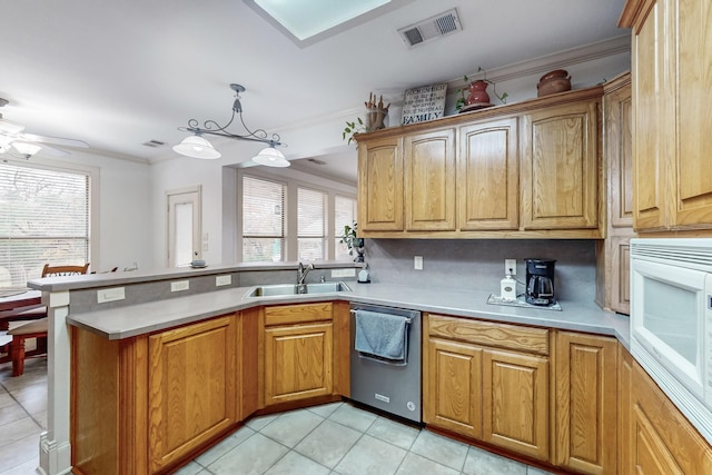 kitchen featuring white microwave, decorative backsplash, sink, decorative light fixtures, and stainless steel dishwasher