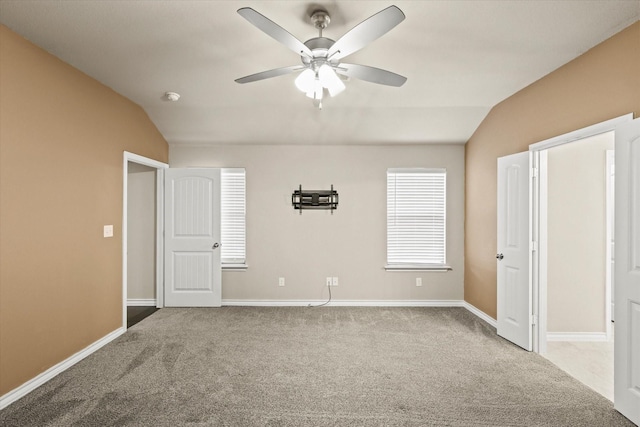 unfurnished bedroom with lofted ceiling, ceiling fan, and carpet flooring