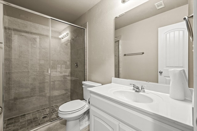 bathroom featuring toilet, walk in shower, and vanity