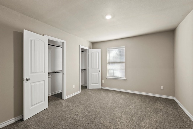 unfurnished bedroom featuring dark carpet