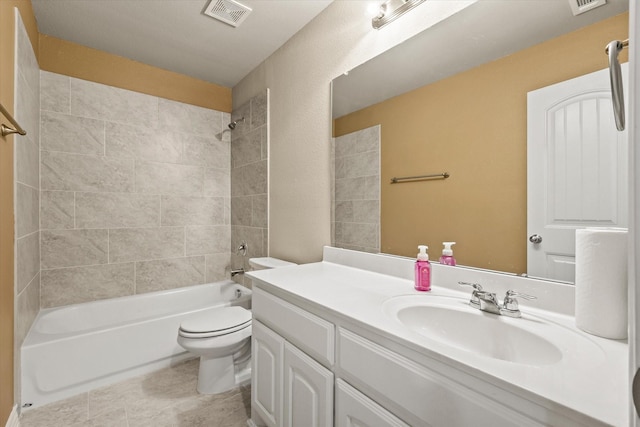 full bathroom featuring vanity, tiled shower / bath combo, and toilet