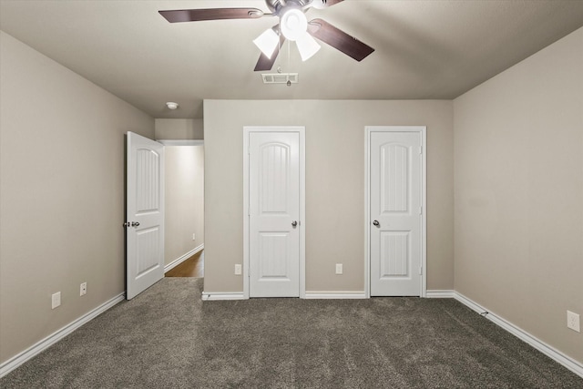 unfurnished bedroom featuring dark carpet and ceiling fan