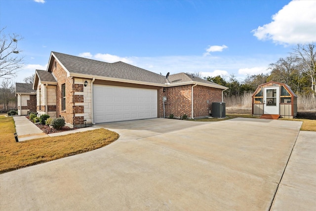 view of side of property with a garage and central AC unit