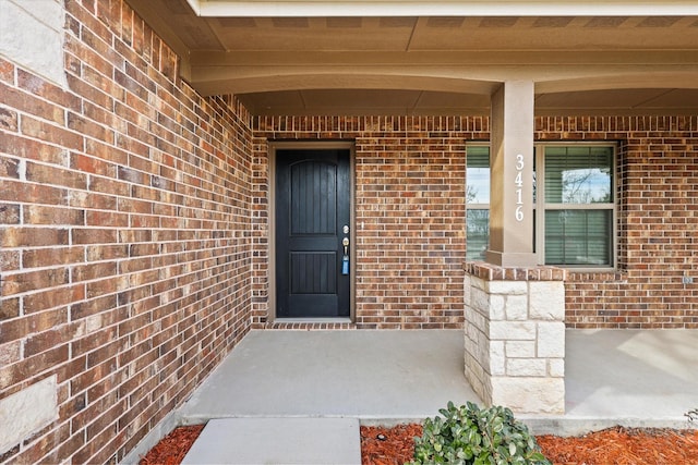 view of exterior entry with covered porch