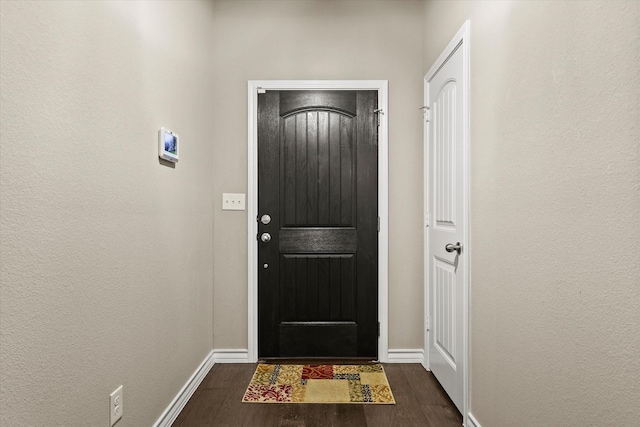 doorway to outside with dark hardwood / wood-style flooring