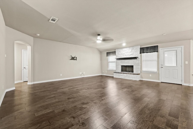 unfurnished living room featuring dark hardwood / wood-style flooring, a fireplace, and ceiling fan