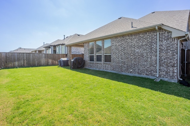 rear view of property with a yard