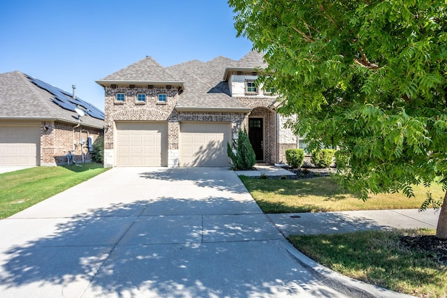 view of front facade featuring a front lawn and a garage