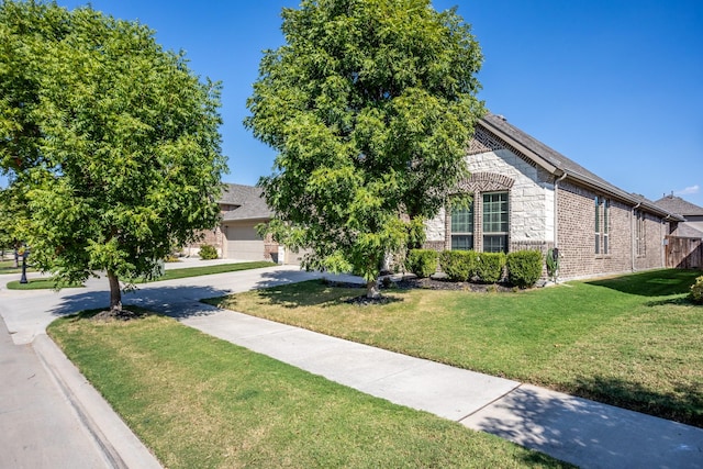 view of property hidden behind natural elements with a front yard