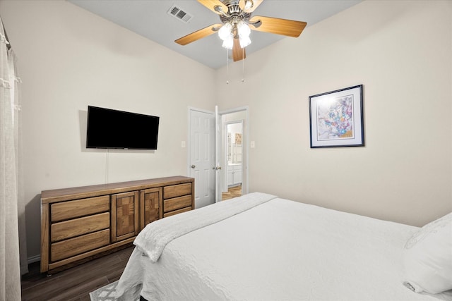 bedroom with dark hardwood / wood-style flooring and ceiling fan