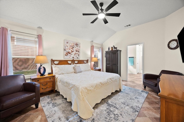 bedroom featuring ceiling fan, connected bathroom, vaulted ceiling, and multiple windows