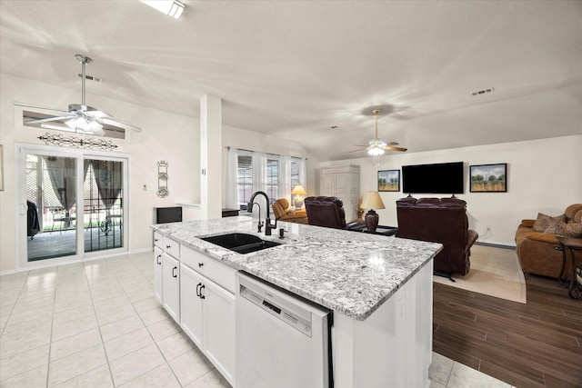 kitchen with sink, white cabinets, light stone counters, a center island with sink, and dishwashing machine