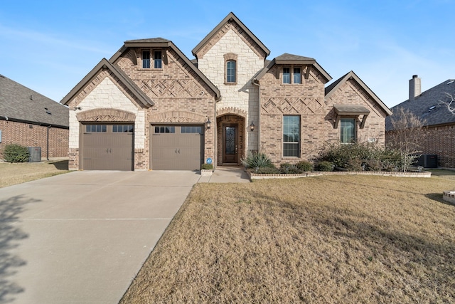 view of front of house with a front yard and a garage