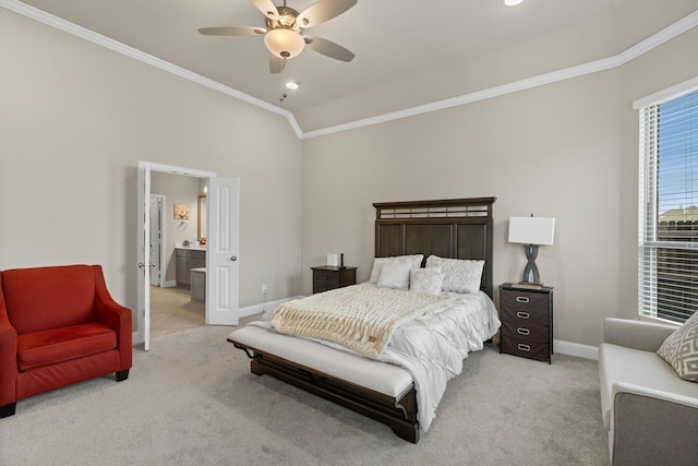 carpeted bedroom featuring connected bathroom, ceiling fan, vaulted ceiling, and ornamental molding