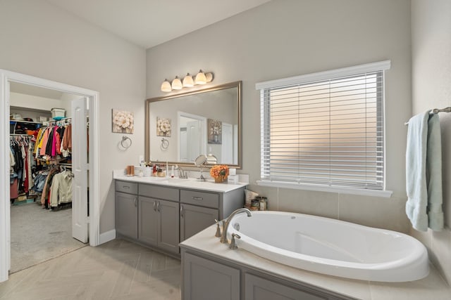 bathroom featuring a bathtub, plenty of natural light, vanity, and parquet flooring