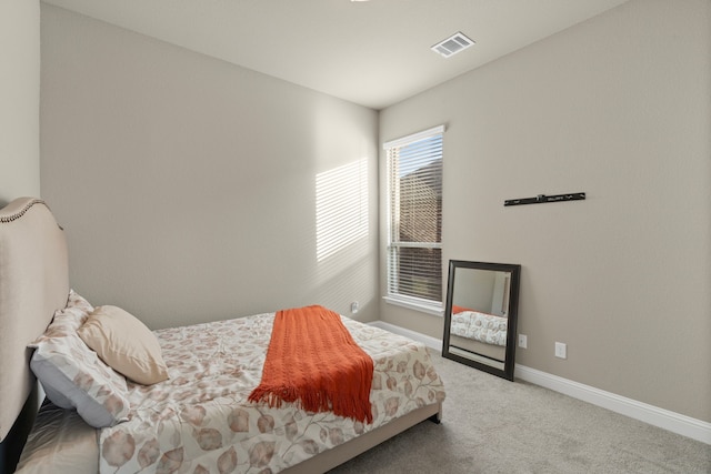 bedroom with light colored carpet