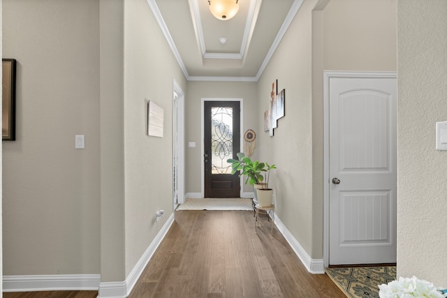 entrance foyer with ornamental molding and hardwood / wood-style floors