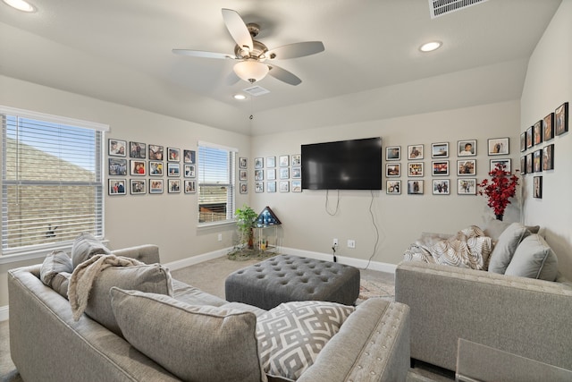 living room with carpet floors, ceiling fan, and vaulted ceiling