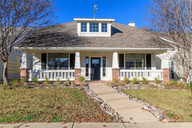 view of front of property with a porch and a front yard