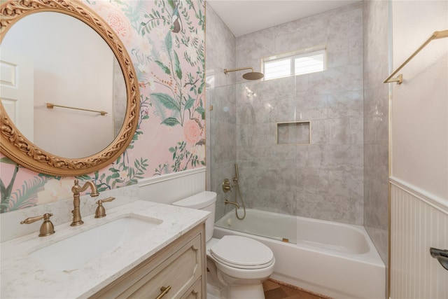 full bathroom with toilet, vanity, and tiled shower / bath