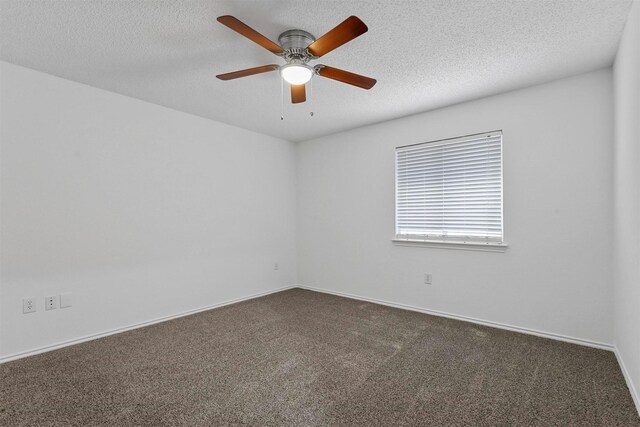 unfurnished room featuring ceiling fan and dark carpet