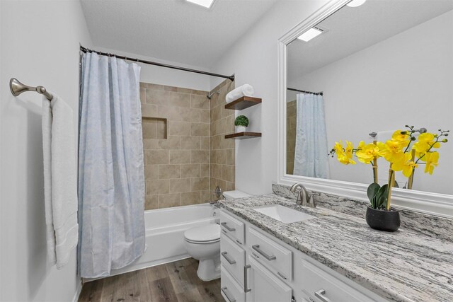 bedroom featuring ceiling fan, dark hardwood / wood-style flooring, vaulted ceiling, and ensuite bath