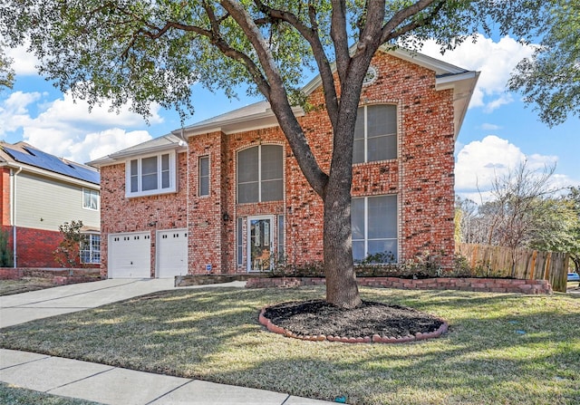 view of front property featuring a garage and a front lawn