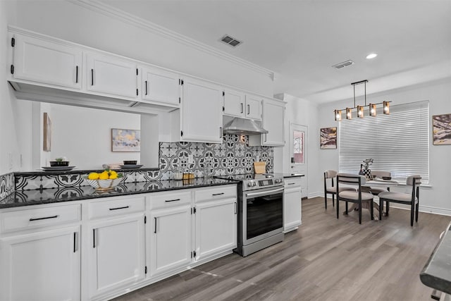 kitchen featuring stainless steel range with electric stovetop, dark stone countertops, decorative light fixtures, and white cabinets