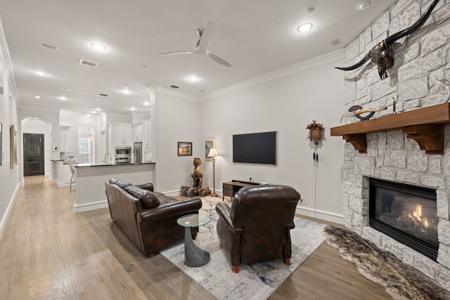 kitchen featuring stainless steel appliances, white cabinets, a center island with sink, and tasteful backsplash