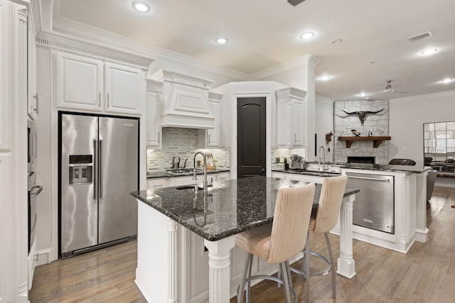 kitchen with white cabinets, sink, and a large island