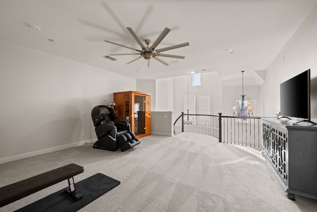 interior space with ceiling fan with notable chandelier and carpet flooring