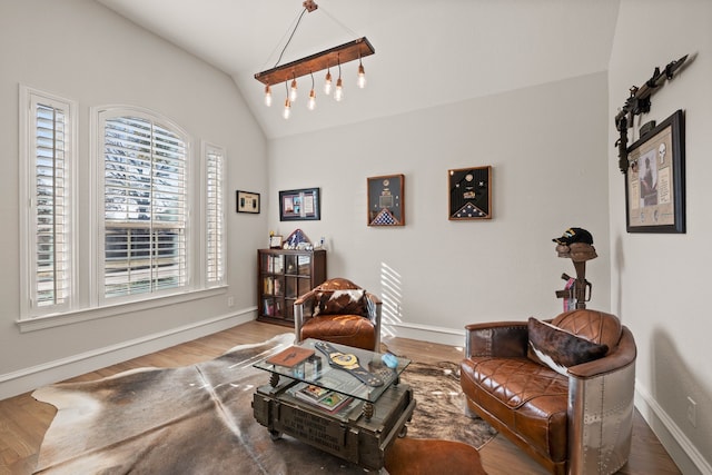 living room featuring ceiling fan, wood-type flooring, a fireplace, and ornamental molding