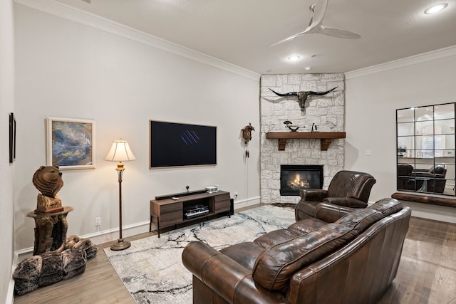 living room with ceiling fan, a fireplace, and crown molding