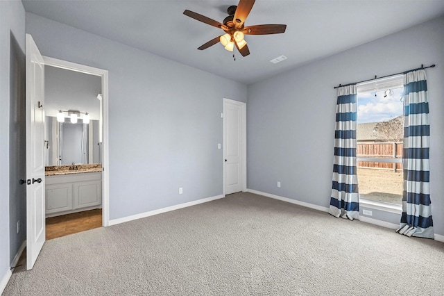 unfurnished bedroom with light carpet, ceiling fan, connected bathroom, and sink