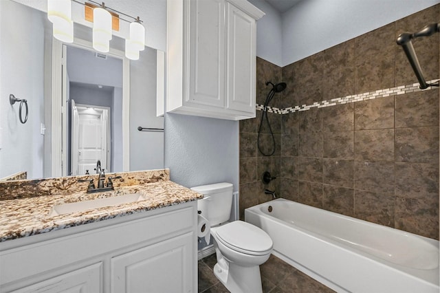 full bathroom with toilet, tiled shower / bath combo, and vanity