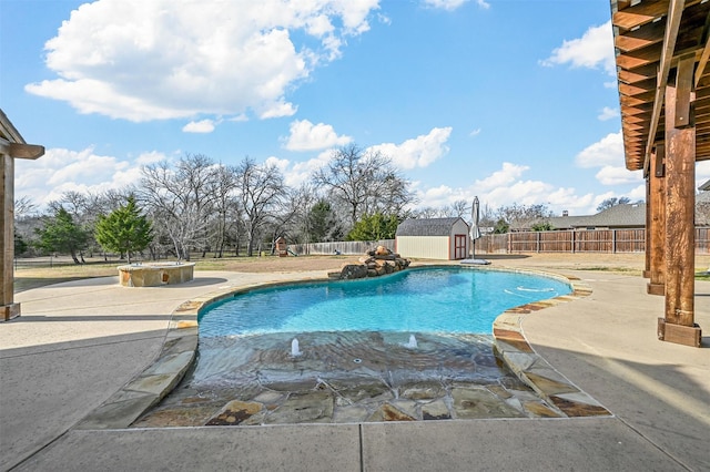 view of swimming pool featuring a hot tub, a patio, and a shed