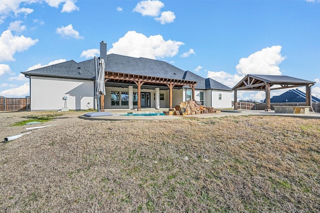 rear view of property with a gazebo and a patio area