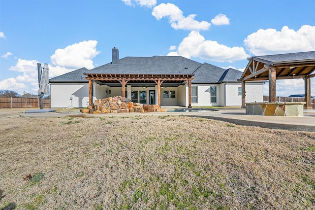 rear view of house with a lawn, a pool, and a patio