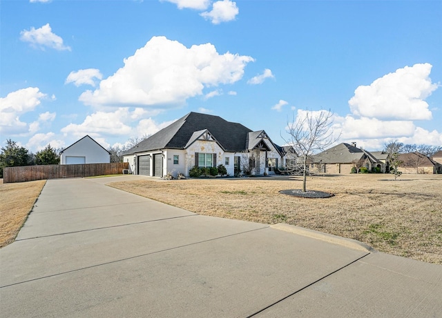 view of front of property with a garage and a front yard